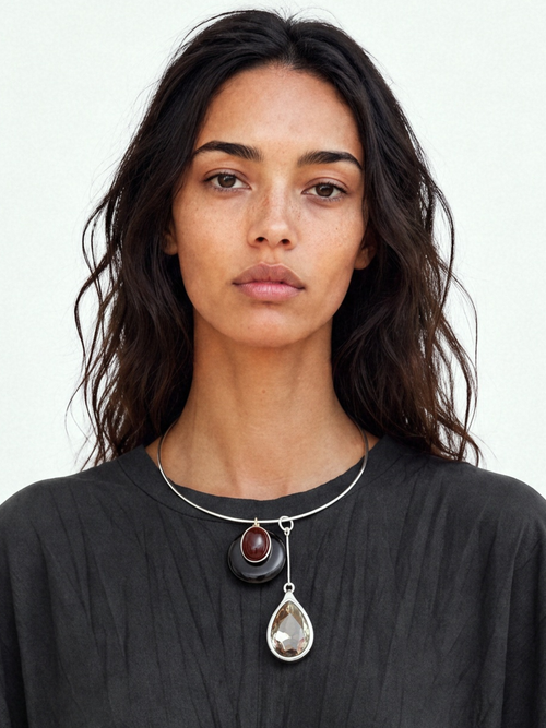 Model wearing the MOUNSER Rega Collar Necklace in Caviar with stacked obsidian and crystal pendants on a silver wire necklace styled with a black tee shirt