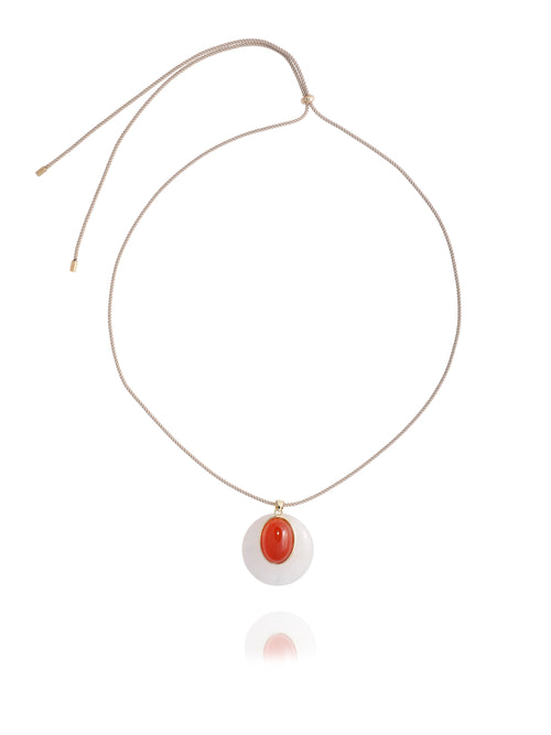MOUNSER Aarnio Pendant in Petal, featuring a layered white quartz disc with red carnelian cabochon and 14k gold-plated brass accents, suspended from an adjustable beige twisted silk cord, on white background.