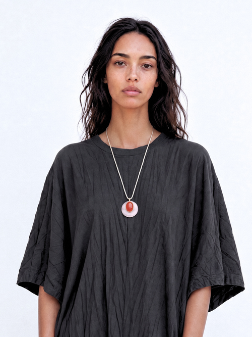  Model wearing the MOUNSER Aarnio Pendant in Petal with white quartz and red carnelian disc pendant on twisted cord.