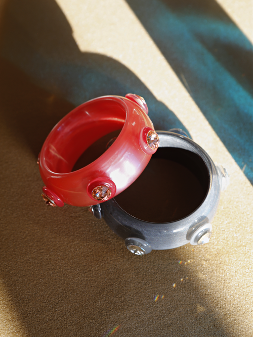 Side view of the MOUNSER Ambrosia Bangle in Balsamic Strawberry displaying its curved sculptural silhouette and glossy finish.