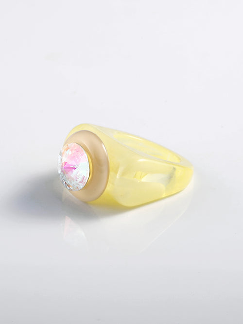 Angled view of MOUNSER Ambrosia Ring in Banana Cream with iridescent crystal and resin band