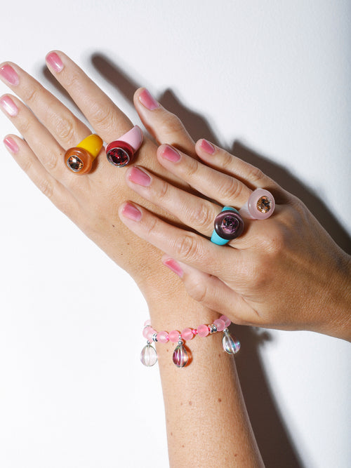 Model shot of MOUNSER Bliss Ring in Blush a delicate and minimal acrylic cocktail ring in a jewel toned palette with a Swarovski crystal gemstone.  