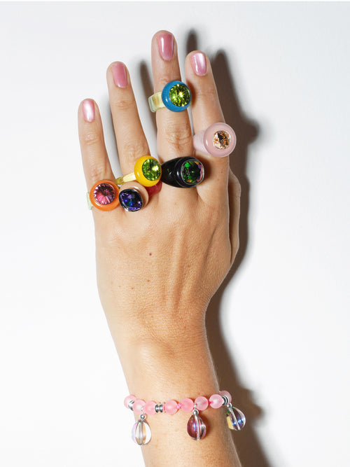 Studio shot of MOUNSER Bliss Ring in Blush a delicate and minimal acrylic cocktail ring in a jewel toned palette with a Swarovski crystal gemstone.  