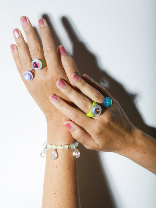 Close up of MOUNSER Bliss Ring in Cherry Blossom a delicate and minimal acrylic cocktail ring in a jewel toned palette with a Swarovski crystal gemstone.  