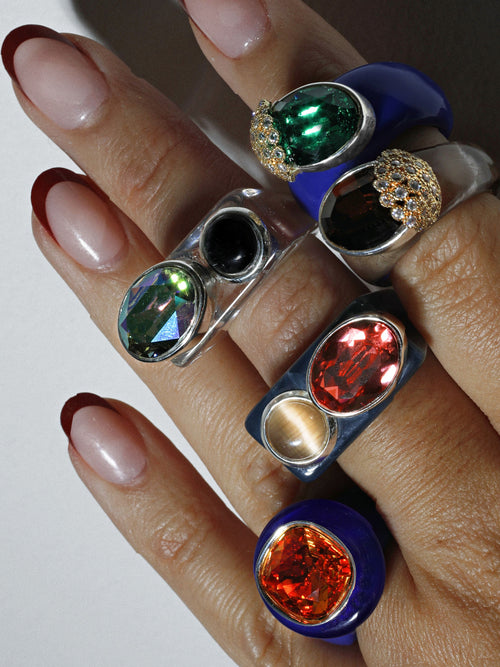 Close up view of MOUNSER Couplet Ring in Denim Blue a jewel toned dual stone ring featuring a Swarovski rhinestone and natural gemstone cabochon on a lucite band