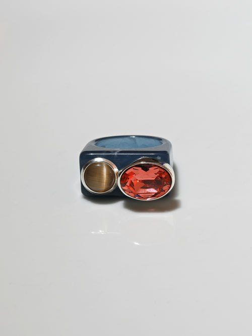 contrast shot of MOUNSER Couplet Ring in Denim Blue a jewel toned dual stone ring featuring a Swarovski rhinestone and natural gemstone cabochon on a lucite band.