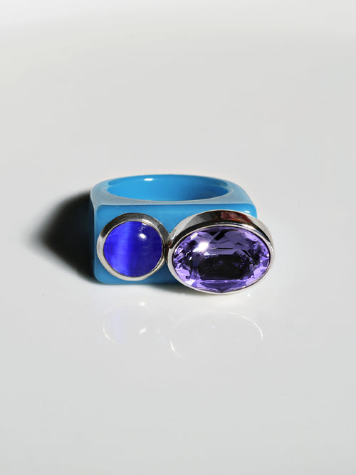 contrast shot of MOUNSER Couplet Ring in Hydrangea a jewel toned dual stone ring featuring a Swarovski rhinestone and natural gemstone cabochon on a lucite band.