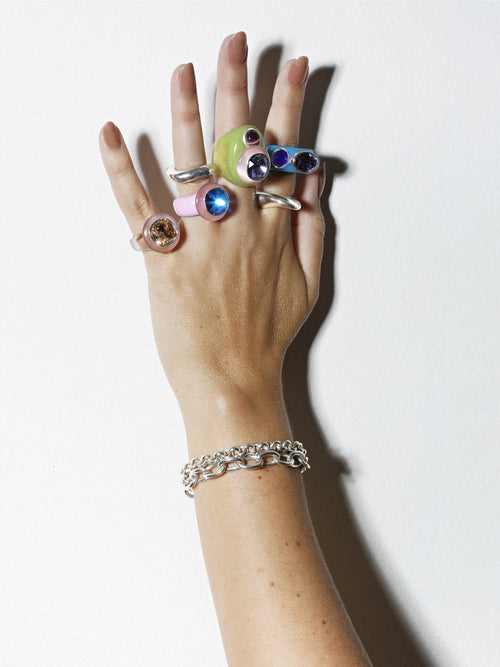 studio shot of MOUNSER Couplet Ring in Hydrangea a jewel toned dual stone ring featuring a Swarovski rhinestone and natural gemstone cabochon on a lucite band.