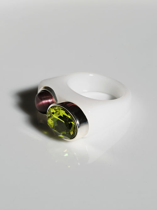 Angle view of MOUNSER Couplet Ring in Olive a jewel toned dual stone ring featuring a Swarovski rhinestone and natural gemstone cabochon on a lucite band