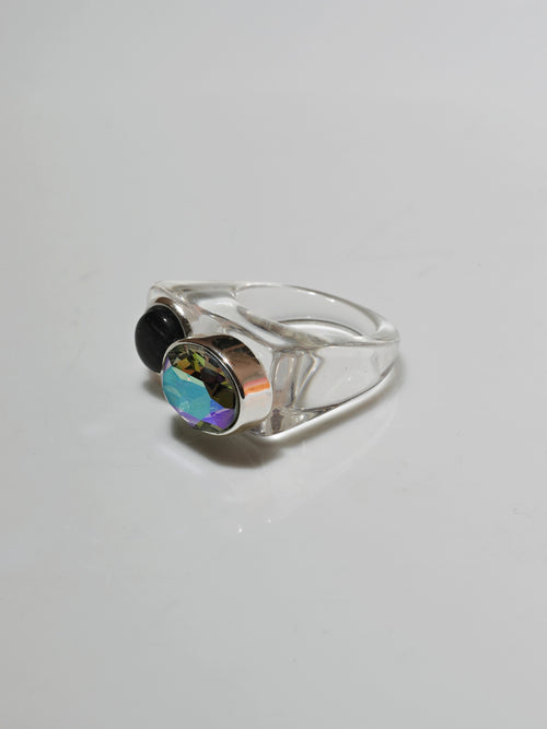 Angle view of MOUNSER Couplet Ring in On Ice a jewel toned dual stone ring featuring a Swarovski rhinestone and natural gemstone cabochon on a lucite band