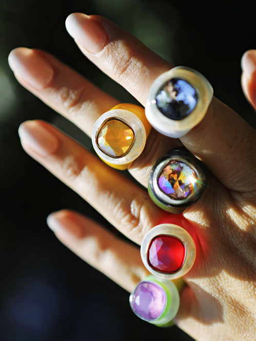 Outdoor shot of model wearing MOUNSER Daydream Ring in Jacaranda and colorful acrylic resin ring collection