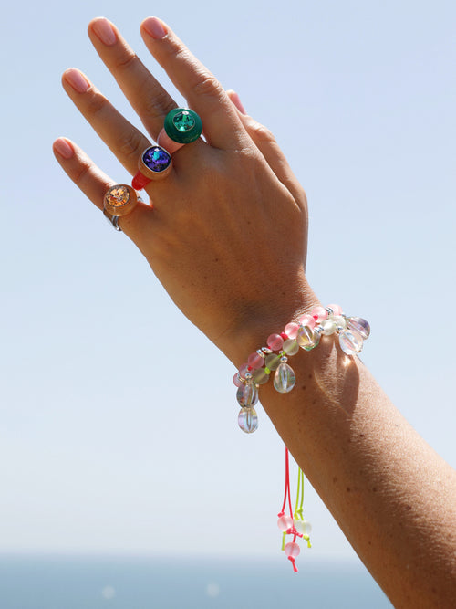 hand shot of MOUNSER Disco Pinky Ring in Apricot featuring colorful acrylic resin and Swarovski crystal gemstone