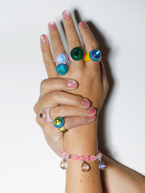 hand shot of MOUNSER Disco Pinky Ring in Pistachio featuring colorful acrylic resin and Swarovski crystal gemstone