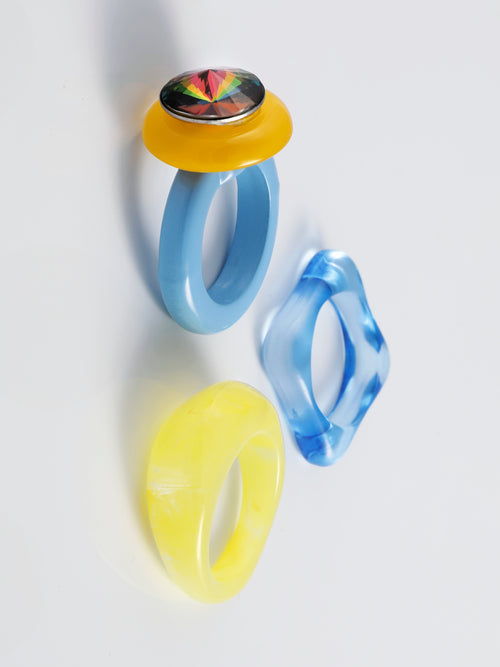 Angel shot of MOUNSER Electric Disco Ring Set in Cerulean Ember, a curated trio of stackable resin rings, anchored by a focal with with a sparkling circular Austrian crystal gem