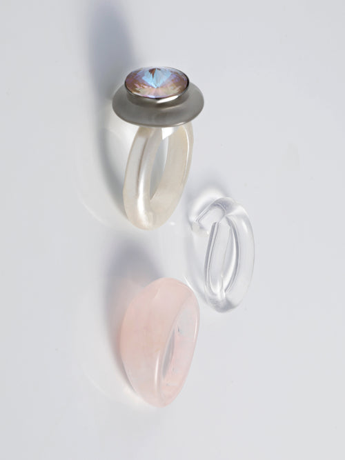Angel shot of MOUNSER Electric Disco Ring Set in Fog Machine, a curated trio of stackable resin rings, anchored by a focal with with a sparkling circular Austrian crystal gem
