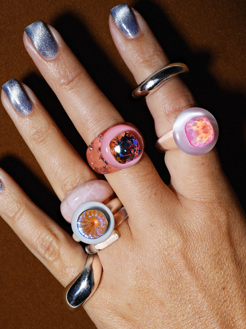 Model shot of MOUNSER Electric Disco Ring Set in Fog Machine, a curated trio of stackable resin rings, anchored by a focal with with a sparkling circular Austrian crystal gem