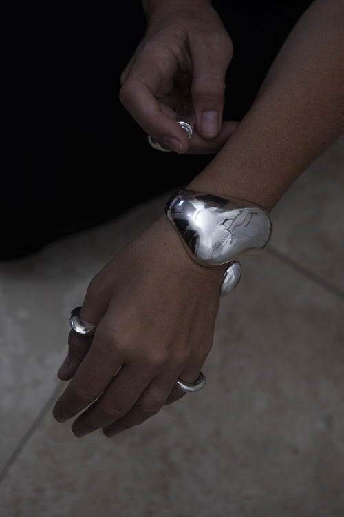 on hand shot of MOUNSER Large Buck Cuff Bracelet in Sterling Silver sculptural statement cuff bracelet with a puffed voluminous shape and a high polished glossy finish
