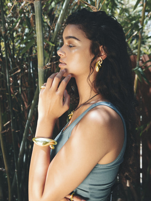 Profile shot of MOUNSER Large Egg Earrings in Sterling Silver & Gold Vermeil, handcrafted sculptural free form egg shape earrings with a mirror polish.