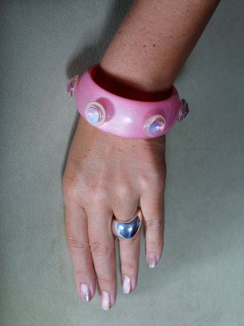 Studio hand shot of MOUNSER Large Oak Ring in Sterling Silver featuring a sculptural, amorphous high-polish silhouette