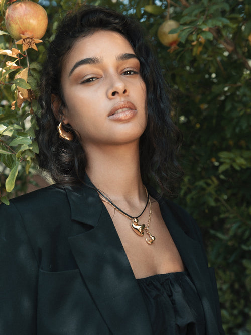 model shot of MOUNSER Large Rose Hoop Earrings in Sterling Silver and gold vermeil, handcrafted sculptural free form earrings with a mirror polish