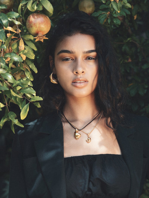 outdoor shot of MOUNSER Large Rose Hoop Earrings in Sterling Silver and gold vermeil, handcrafted sculptural free form earrings with a mirror polish