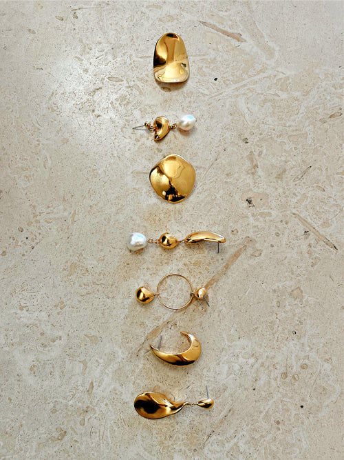 still life of MOUNSER Lunar Earrings in Gold sculptural free form teardrop earring