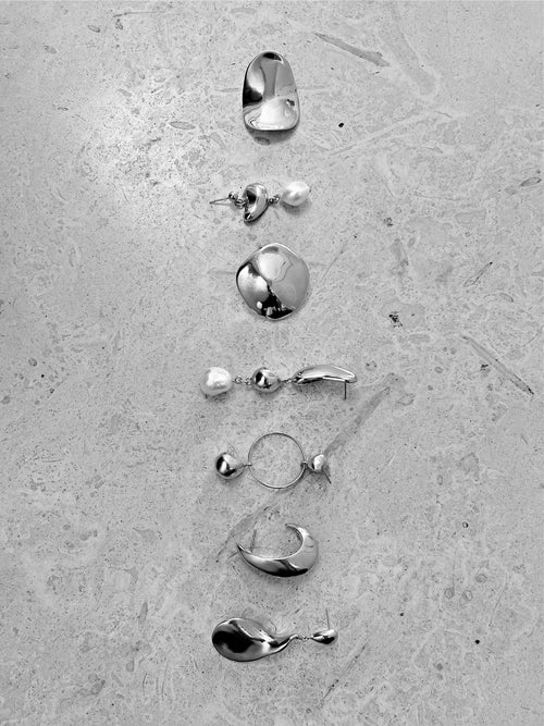 still life of MOUNSER Lunar Earrings in Silver sculptural free form teardrop earring