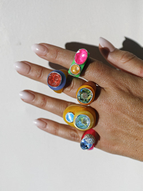 model shot of MOUNSER Nest Ring in Bikini featuring a brilliant Swarovski crystal, pavé rhinestone detailing and colorful acrylic resin ring band.