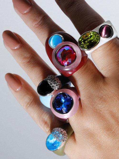 close up of MOUNSER Nest Ring in Miragefeaturing a brilliant Swarovski crystal, pavé rhinestone detailing and colorful acrylic resin ring band.