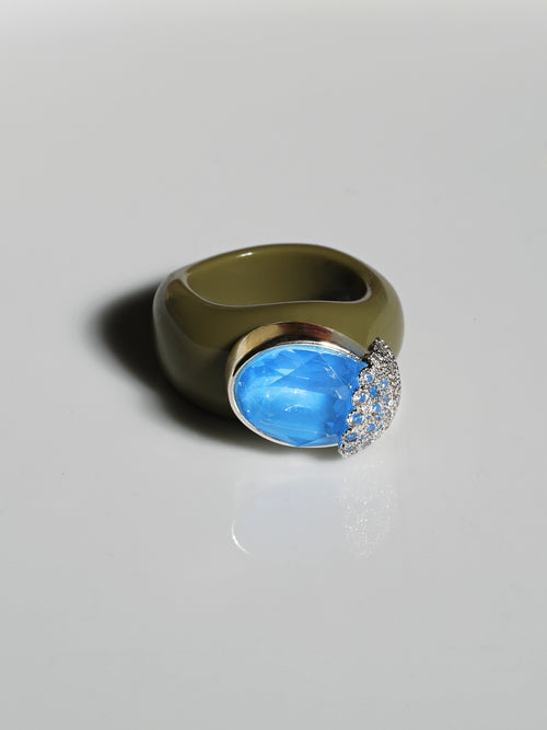 contrast shot of MOUNSER Nest Ring in Mirage featuring a brilliant Swarovski crystal, pavé rhinestone detailing and colorful acrylic resin ring band.