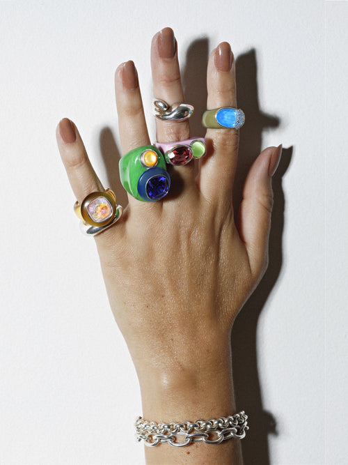model shot of MOUNSER Nest Ring in Mirage featuring a brilliant Swarovski crystal, pavé rhinestone detailing and colorful acrylic resin ring band.