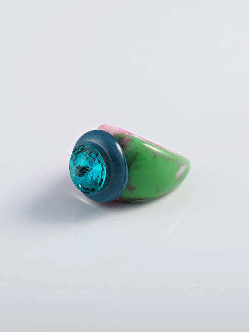 Angle shot of MOUNSER Raw Gradient Psychedelia Ring in Aqua Nocturne featuring a cushion-cut Austrian crystal and colorful acrylic resin band in tie-dyed effect