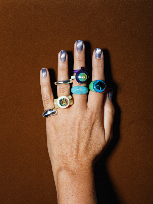 Shot on model of MOUNSER Raw Gradient Psychedelia Ring in Aqua Nocturne featuring a cushion-cut Austrian crystal and colorful acrylic resin band in tie-dyed effect