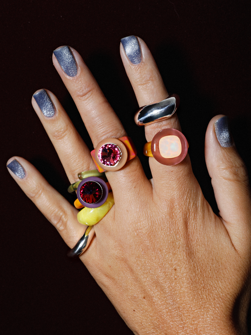 Shot on hand of MOUNSER Raw Gradient Psychedelia Ring in Rose Mirage featuring a cushion-cut Austrian crystal and colorful acrylic resin band in tie-dyed effect