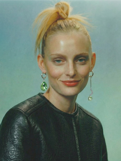 model shot of MOUNSER Sea Foam Earrings mismatched earring pair featuring high-polished sterling silver hoops adorned with a jumbo Austrian crystal teardrop, along with an elongated crystal rhinestone and cubic zirconia charm.