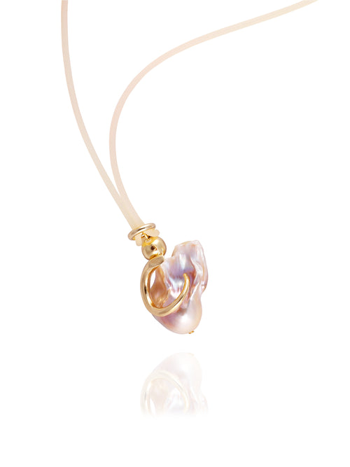 Close up detail shot of MOUNSER Seaside Souvenir Necklace in Bermuda showing sculptural freshwater pearl pendant cord necklace