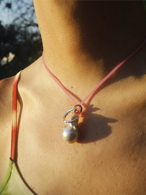 Close detail of MOUNSER Seaside Souvenir Necklace in Oahu showing sculptural freshwater pearl pendant