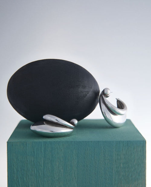 still life of MOUNSER Small Blue Hoop Earrings in Sterling Silver sculptural free-form earrings designed as a single style with the illusion of multiple stacked piercings