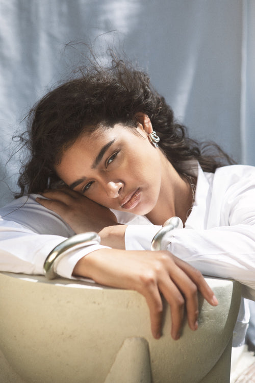 studio shot of MOUNSER Small Ice Moon Hoop Earrings in Sterling silver, a sculptural free-form earring designed as a single style with the illusion of multiple stacked piercings.