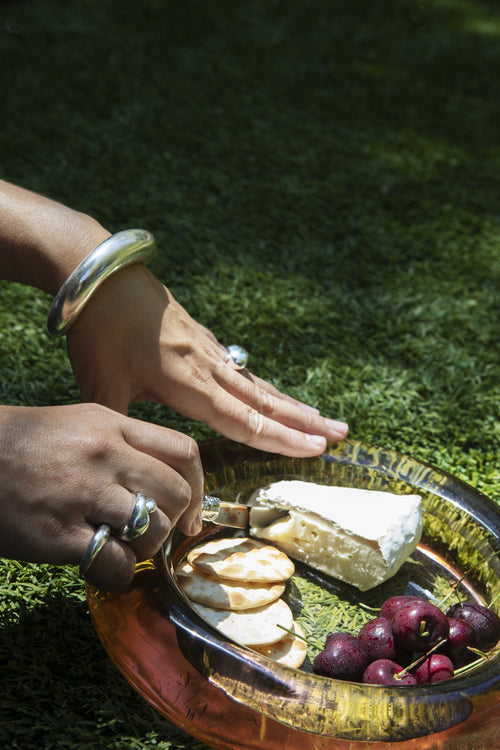 Outdoor hand shot of MOUNSER Small Oak Ring in Sterling Silver featuring a sculptural, amorphous high-polish silhouette