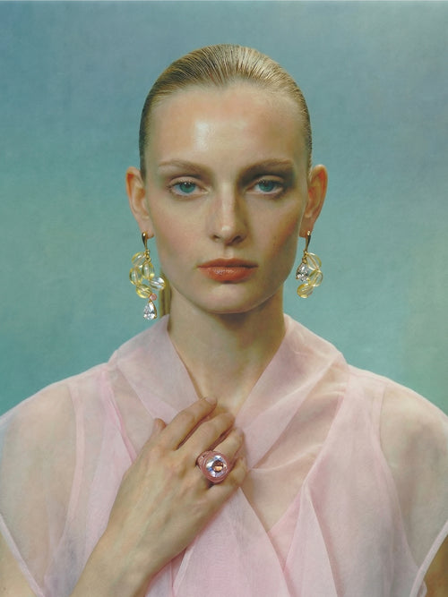 model shot of MOUNSER Soap Earrings in Bubble Yellow designer sculptural glass asymmetric statement earrings.