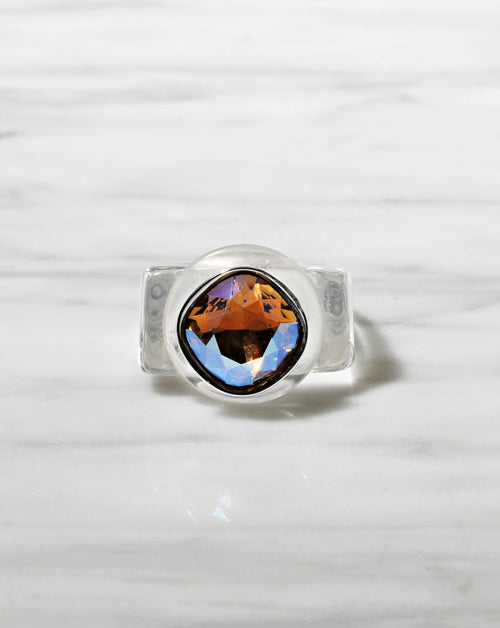 contrast shot of MOUNSER Spectrum Ring in H2O featuring a richly colored acrylic ring band with a sparkling colorful Swarovski crystal.