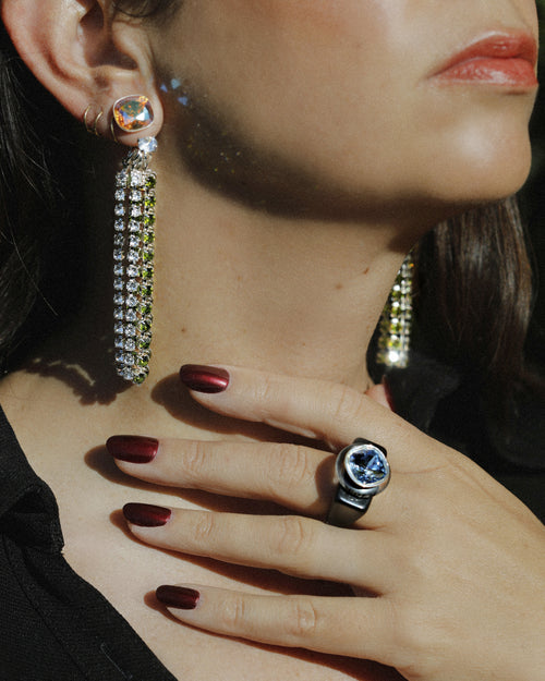 detail shot of MOUNSER Spectrum Ring in Nox featuring a richly colored acrylic ring band with a sparkling colorful Swarovski crystal.
