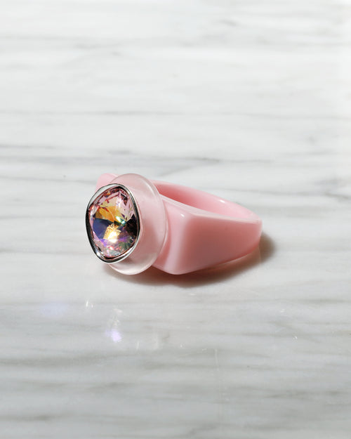 angle shot of MOUNSER Spectrum Ring in Roseus featuring a richly colored acrylic ring band with a sparkling colorful Swarovski crystal.