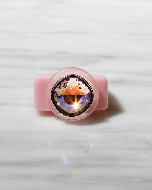 contrast shot of MOUNSER Spectrum Ring in Roseus featuring a richly colored acrylic ring band with a sparkling colorful Swarovski crystal.