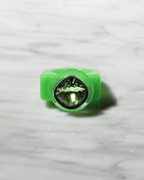 contrast shot of MOUNSER Spectrum Ring in Viridescent featuring a richly colored acrylic ring band with a sparkling colorful Swarovski crystal.