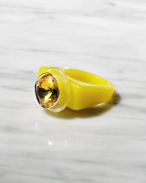 angle shot of MOUNSER Spectrum Ring in Xanthophylls featuring a richly colored acrylic ring band with a sparkling colorful Swarovski crystal.