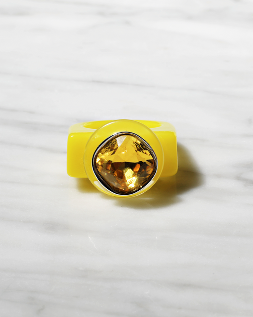 contrast shot of MOUNSER Spectrum Ring in Xanthophylls featuring a richly colored acrylic ring band with a sparkling colorful Swarovski crystal.