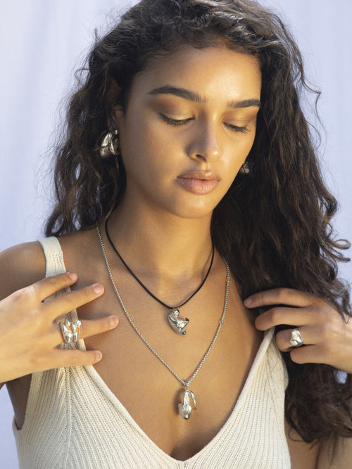 MOUNSER Strawberry Ring in sterling silver worn on model showing organic sculptural shape and mirror finish