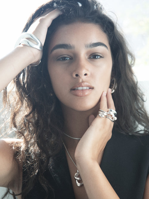 MOUNSER Travel Ring in sterling silver worn on model showing organic sculptural shape and mirror finish